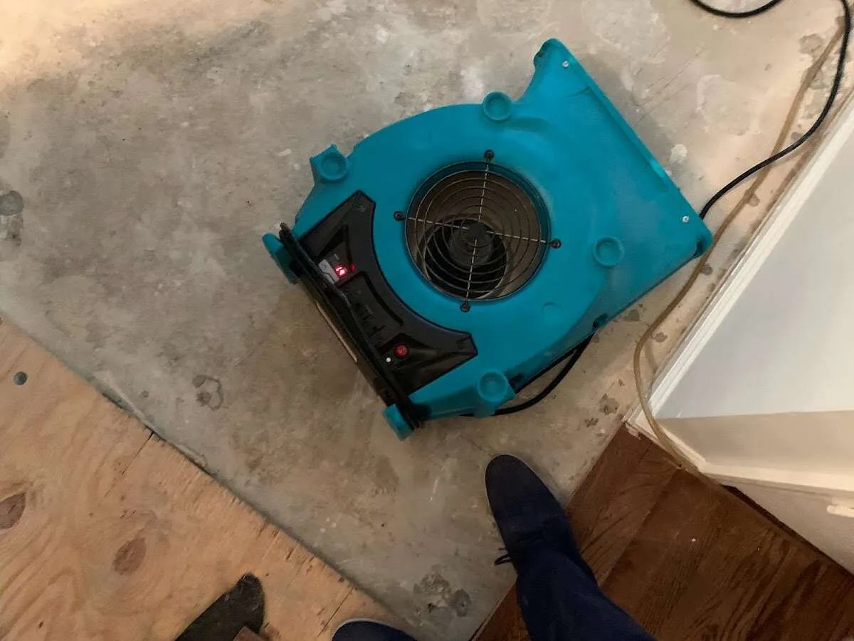 Air mover drying subfloor during Commercial Water Damage Restoration in Indiantown